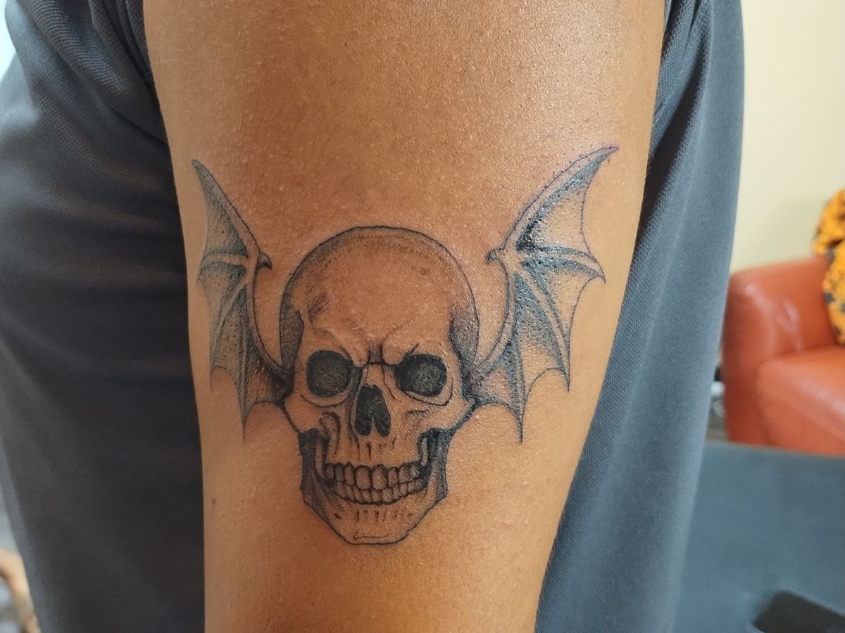 Black and gray skull tattoo by Courtney at Earth’s Edge Tattoo & Piercing