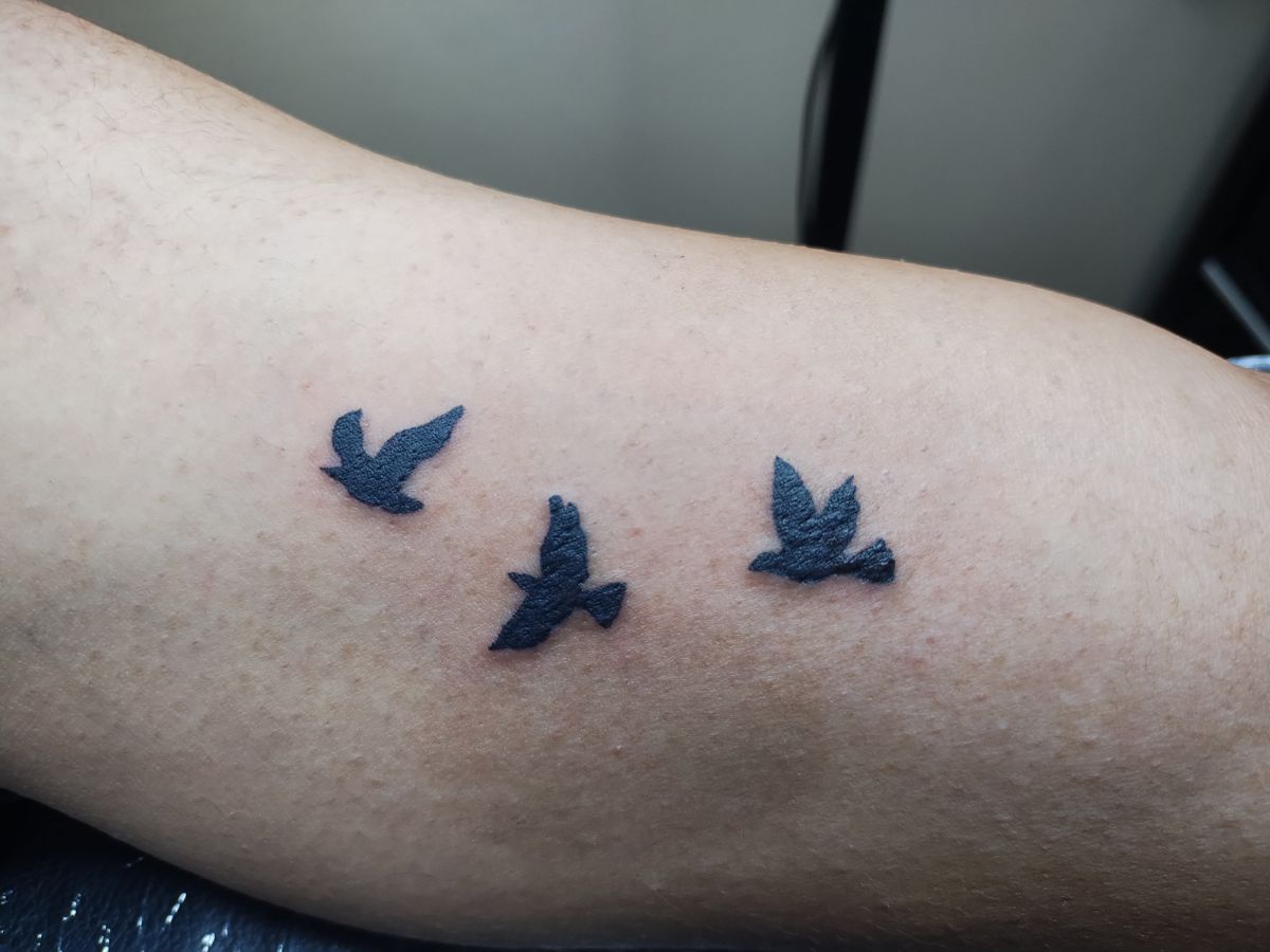 Minimalist bird tattoo by Courtney at Earth’s Edge Tattoo & Piercing