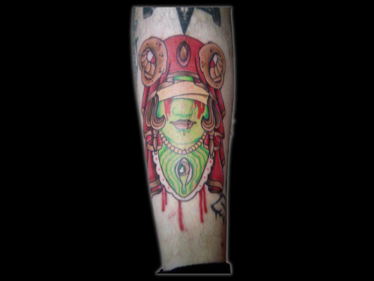 Green lady portrait tattoo in a classic traditional style by Greg at Earth’s Edge.