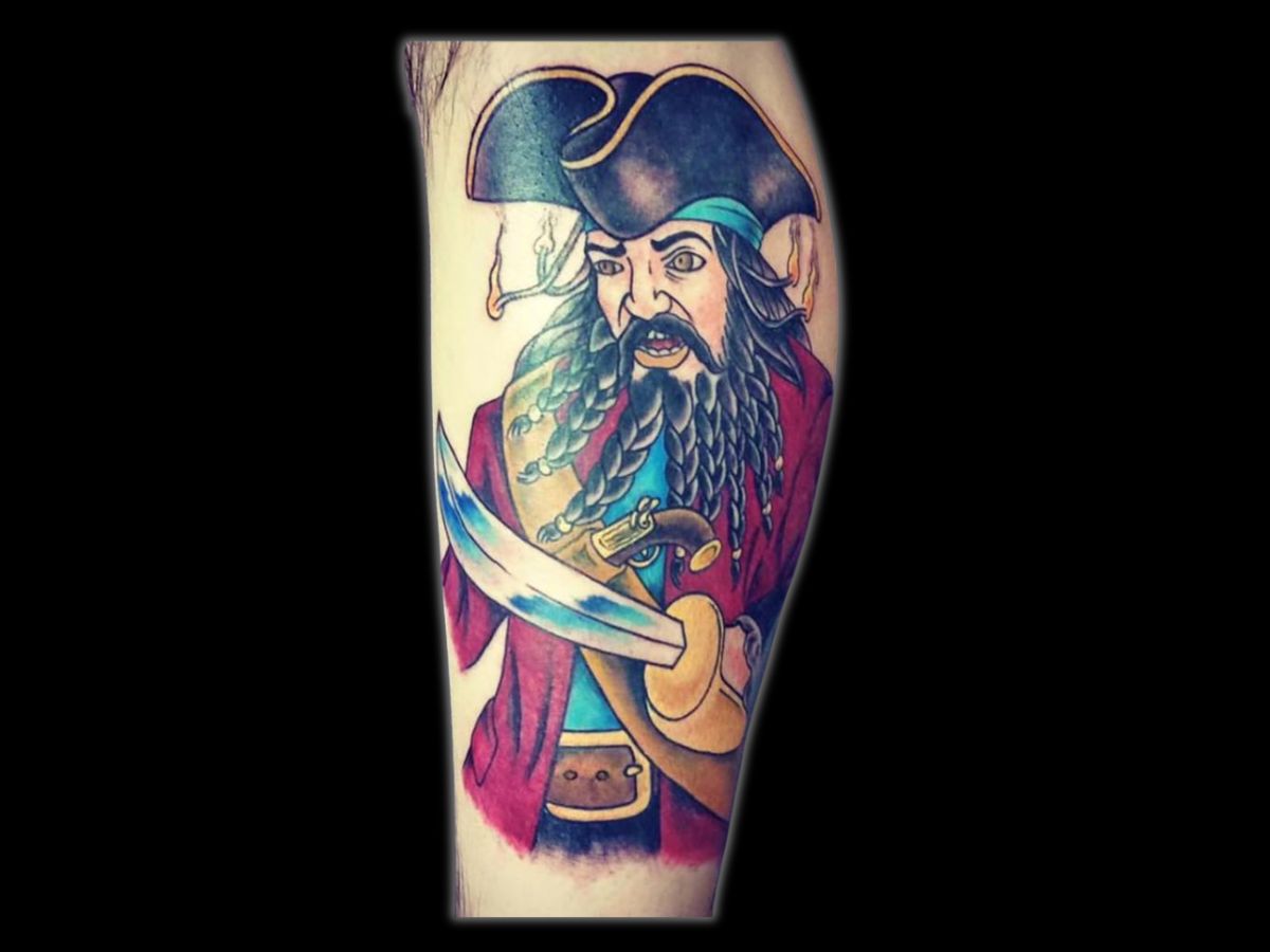 Traditional pirate head tattoo with bold lines by Greg at Earth’s Edge.