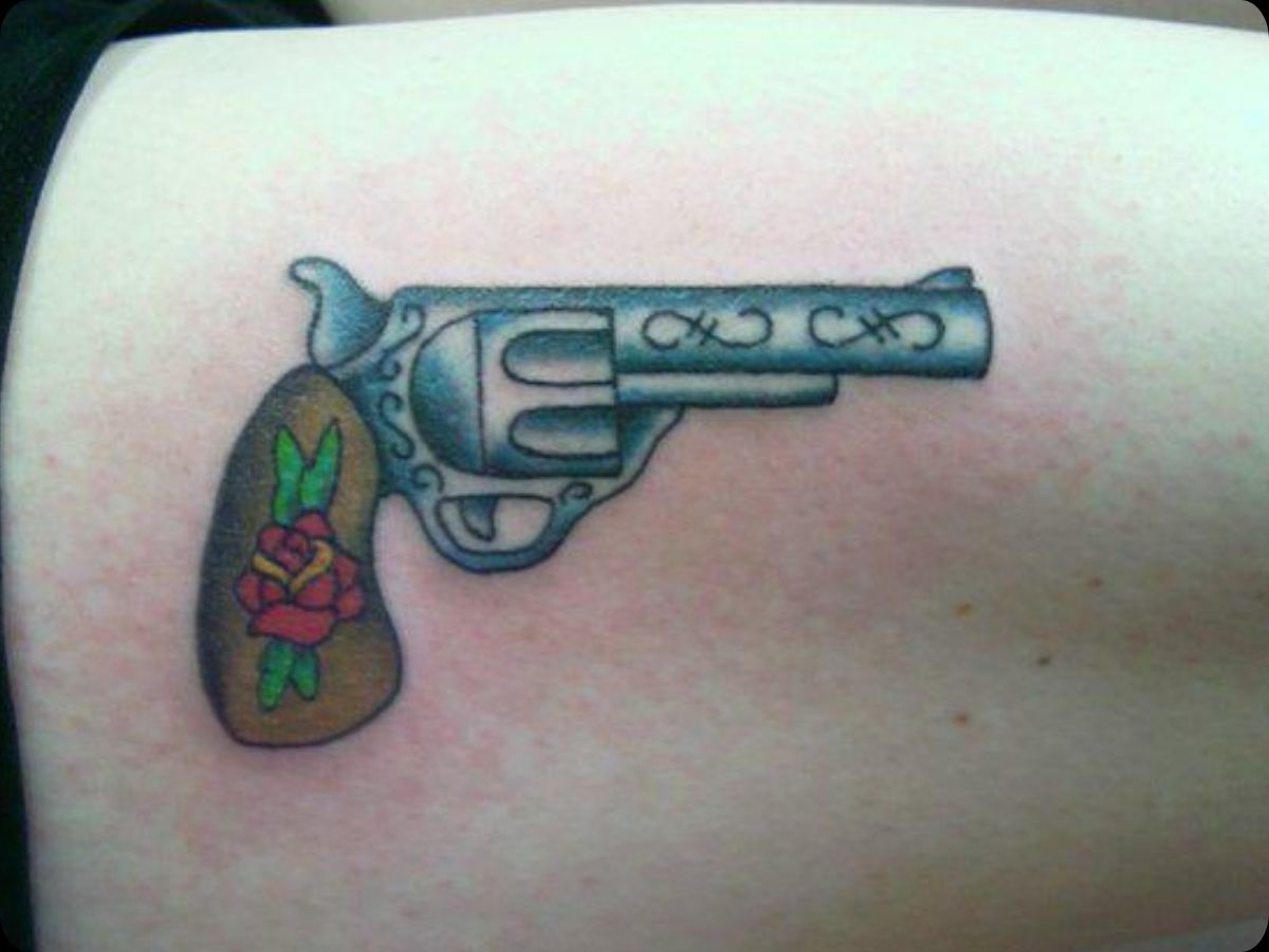 Traditional pistol tattoo in bold black and shading by Greg at Earth’s Edge.