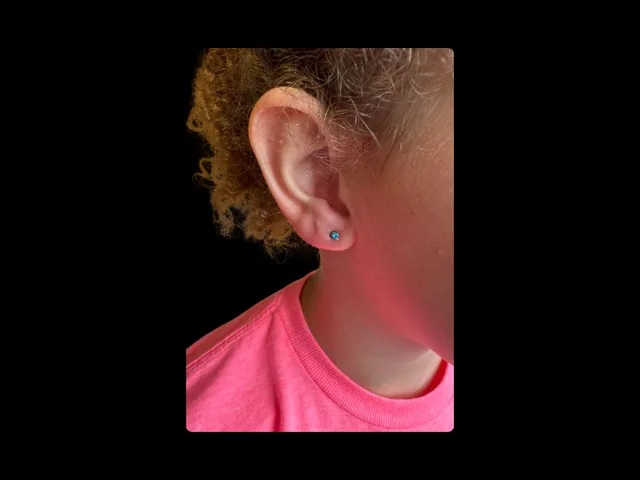 Child ear lobe piercing by Josh at Earth’s Edge Tattoo & Piercing in Winston-Salem, NC