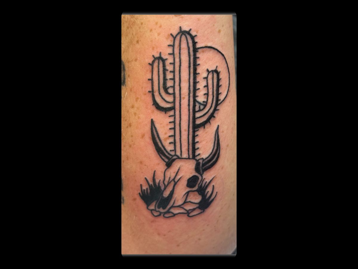 Cactus and skull tattoo by Robert — traditional composition with texture.