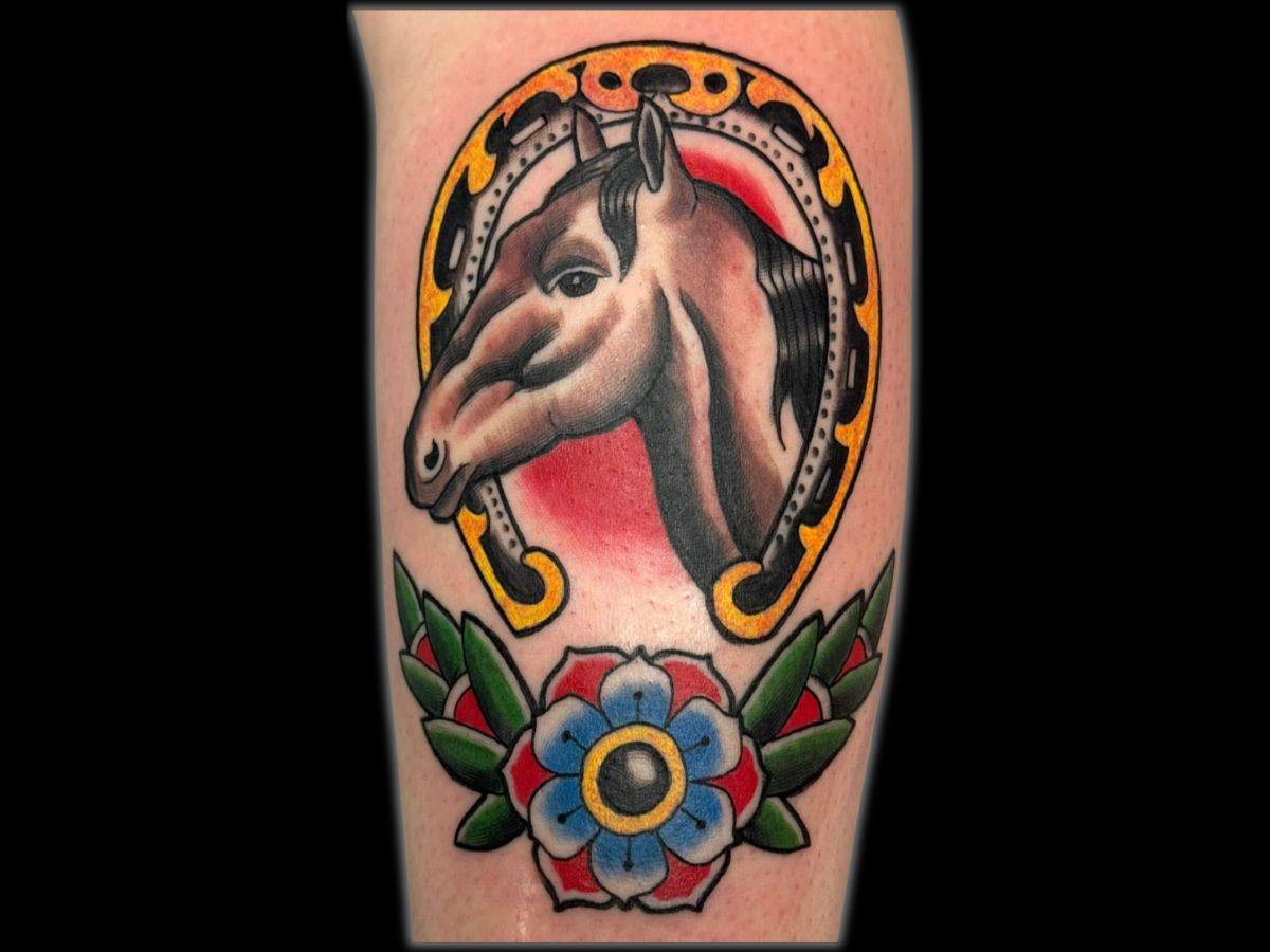 Traditional horse tattoo by Robert — strong black shading and red highlights.