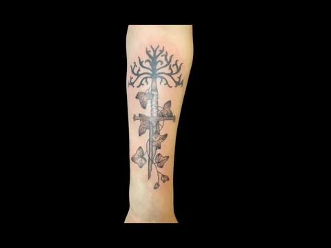 Fine line sword and ivy forearm tattoo by Sharlotte K. at Earth’s Edge Tattoo & Piercing in Winston-Salem, NC