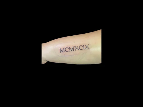 Roman numeral forearm tattoo by Sharlotte K. at Earth’s Edge Tattoo & Piercing in Winston-Salem, NC